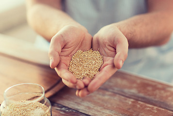Image showing cloes up of male cupped hands with quinoa