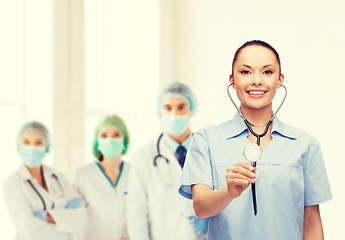 Image showing smiling female doctor or nurse with stethoscope