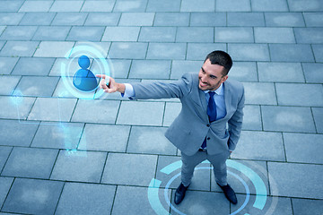 Image showing young smiling businessman outdoors from top