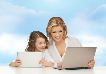 Image showing mother with girl looking to laptop and tablet pc