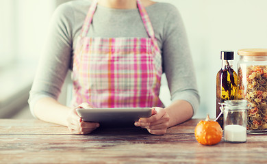 Image showing closeup of woman reading recipe from tablet pc