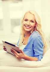 Image showing smiling woman with tablet pc computer at home