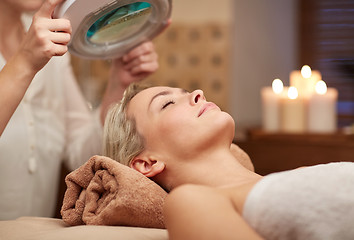 Image showing close up of young woman lying in spa