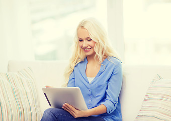 Image showing smiling woman with tablet pc computer at home