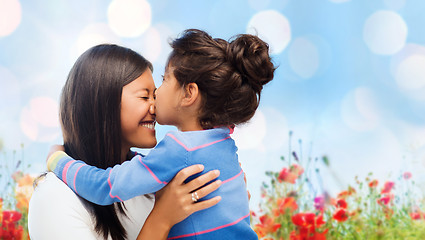 Image showing happy little girl hugging and kissing her mother