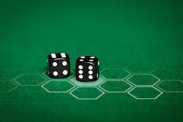 Image showing close up of black dice on green casino table