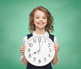 Image showing smiling girl holding big clock