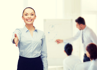 Image showing businesswoman with opened hand ready for handshake