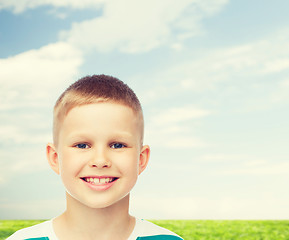 Image showing smiling little boy over natural background