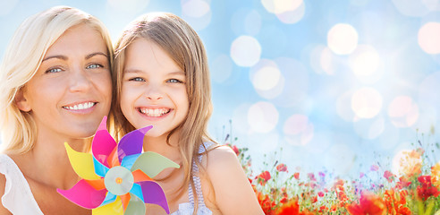 Image showing happy mother and little girl with pinwheel toy