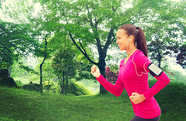 Image showing smiling young woman running outdoors