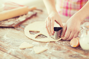 Image showing close up of hands making cookies from fresh dough