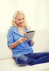 Image showing woman with tablet pc and headphones at home