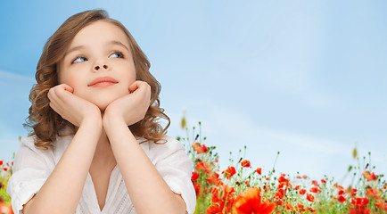 Image showing beautiful girl sitting at table and looking up