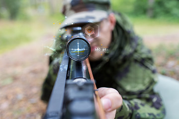 Image showing close up of soldier or sniper with gun in forest