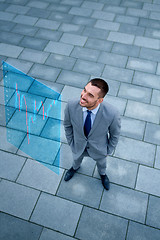 Image showing young smiling businessman outdoors from top