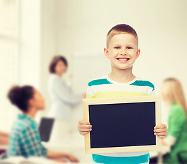 Image showing smiling little boy holding blank black chalkboard