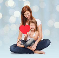 Image showing happy mother with little girl holding red heart