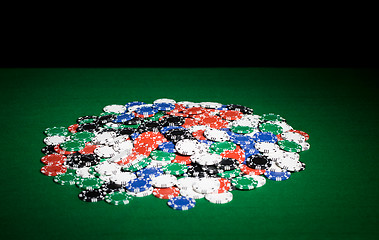 Image showing close up of casino chips on green table surface