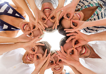 Image showing smiling friends in circle