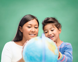 Image showing mother and daughter with globe