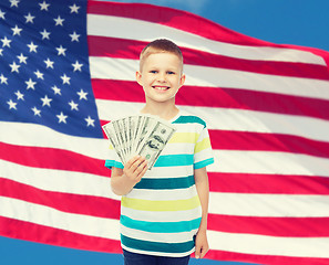 Image showing smiling boy holding dollar cash money in his hand