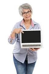 Image showing Elderly woman showing something on a laptop