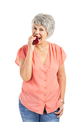 Image showing Old woman eating an apple