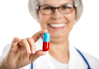 Image showing Female doctor holding  a pill