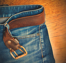 Image showing blue jeans with a leather belt