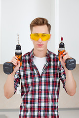 Image showing master with screwdriver and drill 