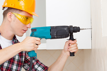 Image showing worker with drill