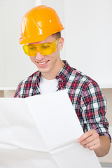 Image showing smiling architect  with repair plan