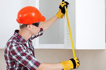 Image showing worker with a tape measure