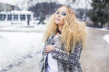 Image showing Blonde lady is posing in the city park