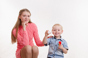Image showing Mom and son blow bubbles