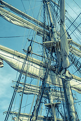 Image showing Sails and tackles of a sailing vessel on a background of the sky