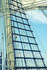 Image showing Sails and tackles of a sailing vessel on a background of the sky