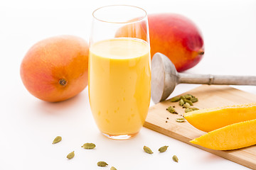 Image showing Mango Milkshake, Two Mangos And Fruit Slices