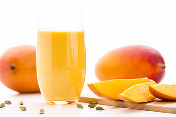 Image showing Cut Mango Pieces, Cardamon And Fruit Shake