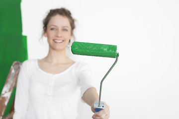 Image showing Woman with green paint roller