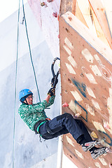 Image showing Man climbs upward on ice climbing competition
