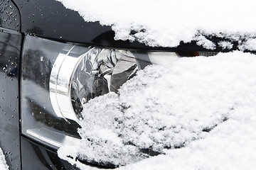 Image showing Snowed car headlights in winter