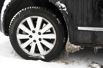 Image showing Frozen ice on car tires 