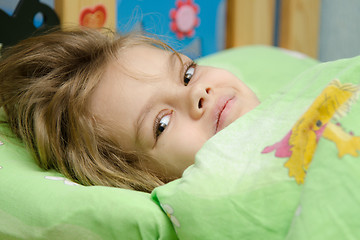 Image showing The girl woke up in bed