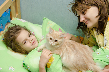 Image showing Mom and daughter in the morning awake cat