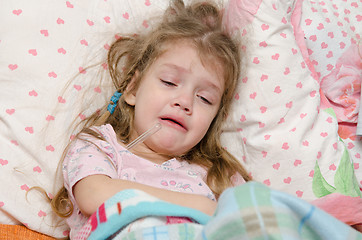 Image showing Four-year girl cries from large temperature