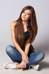 Image showing Teen woman sitting on floor