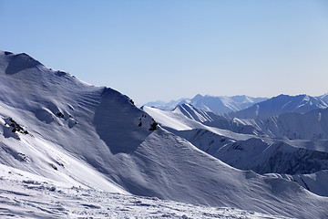 Image showing Off-piste slope and snowy mountains in morning