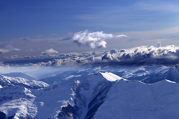 Image showing Winter mountains at evening and sunlight clouds